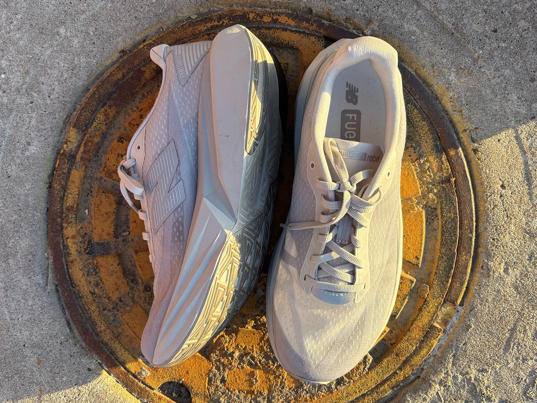 Pair New Balance FuelCell Rebel V5 on a manhole cover Pair New Balance FuelCell Rebel V5 on a manhole cover