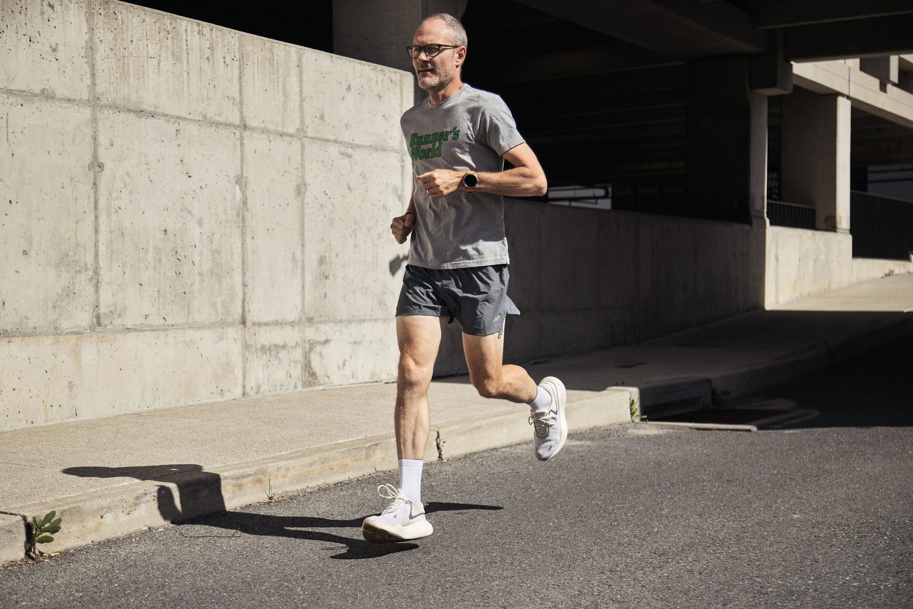 Person jogging on a city sidewalk in casual athletic attire. Person jogging on a city sidewalk in casual athletic attire.